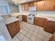 Well-lit kitchen featuring tiled floors and white appliances at 6908 Dorita Ave # 101, Las Vegas, NV 89108