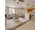 Inviting living room featuring neutral decor, a fireplace, and an open layout connecting to the kitchen at 6908 Dorita Ave # 101, Las Vegas, NV 89108