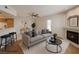 Virtually staged living room with modern decor, a fireplace, and bar-style seating at 6908 Dorita Ave # 101, Las Vegas, NV 89108