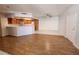 Open-concept living room with wood and tile flooring connected to kitchen at 6908 Dorita Ave # 101, Las Vegas, NV 89108