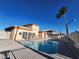 Outdoor community pool with lounge chairs at 6908 Dorita Ave # 101, Las Vegas, NV 89108