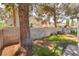 Green backyard featuring a block wall and a large tree at 7617 Sea Cliff Way, Las Vegas, NV 89128