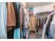 Walk in closet, carpeted with hanging rail and shelves at 7617 Sea Cliff Way, Las Vegas, NV 89128