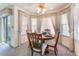 Bright dining area features large windows, and a classic wooden dining set at 7617 Sea Cliff Way, Las Vegas, NV 89128