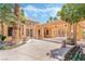 Attractive building exterior with stucco walls, covered entrance, and colorful landscaping at 7617 Sea Cliff Way, Las Vegas, NV 89128