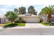 Charming single-story home features a well-manicured lawn and a two-car garage at 7617 Sea Cliff Way, Las Vegas, NV 89128