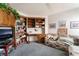 Cozy living room features built in cabinets, desk, shelving, and comfortable seating at 7617 Sea Cliff Way, Las Vegas, NV 89128