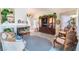 Open-concept living room with fireplace, wooden furniture, and blue carpet at 7617 Sea Cliff Way, Las Vegas, NV 89128