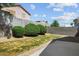 Spacious backyard featuring a concrete patio area, block wall, well-maintained bushes, and easy-care landscaping at 7755 Pacific Rim Ct, Las Vegas, NV 89139