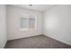 Carpeted bedroom features a window with blinds, ample natural light, and neutral tones at 7755 Pacific Rim Ct, Las Vegas, NV 89139