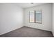 Bright carpeted bedroom featuring a window with blinds and neutral tones at 7755 Pacific Rim Ct, Las Vegas, NV 89139
