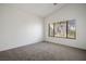 Bedroom features carpeted floors, neutral walls, and a large window at 7755 Pacific Rim Ct, Las Vegas, NV 89139