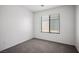Bright, carpeted bedroom featuring a window with blinds and neutral tones at 7755 Pacific Rim Ct, Las Vegas, NV 89139