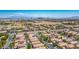 Cityscape view overlooking a community of single-Gathering homes, mature landscaping, and views of Las Vegas at 7755 Pacific Rim Ct, Las Vegas, NV 89139