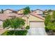 Tan single story home with tile roof and a two car garage at 7755 Pacific Rim Ct, Las Vegas, NV 89139