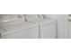 Appliance closet with white, front-loading washer and dryer at 7755 Pacific Rim Ct, Las Vegas, NV 89139