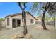 A cozy backyard featuring low-maintenance gravel, trees, and brick patio at 7949 Long Beach St, Las Vegas, NV 89139