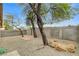 Gravel backyard featuring mature trees and a rock fire pit at 7949 Long Beach St, Las Vegas, NV 89139