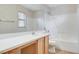 Bathroom with a white vanity, large mirror, and shower over tub at 7949 Long Beach St, Las Vegas, NV 89139