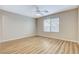 Spacious bedroom with plenty of natural light, wood-look floors, and ceiling fan at 7949 Long Beach St, Las Vegas, NV 89139