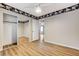 Bright bedroom featuring wood-look floors and closet with mirrored doors at 7949 Long Beach St, Las Vegas, NV 89139