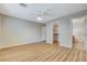 Bright bedroom featuring wood-look floors, ceiling fan, and ensuite bath at 7949 Long Beach St, Las Vegas, NV 89139