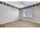 Bedroom with wood-look flooring, neutral wall color, bright ceiling fan and window view at 7949 Long Beach St, Las Vegas, NV 89139