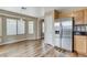 Bright dining area features wood flooring and a stainless steel refrigerator that matches the cabinets at 7949 Long Beach St, Las Vegas, NV 89139