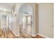 Arched hallway with wood-look flooring, leading to a spacious living area at 7949 Long Beach St, Las Vegas, NV 89139