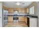 Well-lit kitchen with stainless steel appliances, wood cabinets, and wood-look flooring at 7949 Long Beach St, Las Vegas, NV 89139