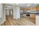 Open kitchen with stainless steel appliances and wood-look flooring, perfect for modern living at 7949 Long Beach St, Las Vegas, NV 89139