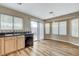 Kitchen sink and breakfast nook area with wood cabinets, sleek countertops and wood-look floors at 7949 Long Beach St, Las Vegas, NV 89139