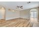 Spacious living room with wood-look floors, arched doorways, and a ceiling fan at 7949 Long Beach St, Las Vegas, NV 89139