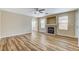 Living room showcasing a fireplace, wood-look floors, and ample natural light at 7949 Long Beach St, Las Vegas, NV 89139