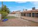 Backyard featuring desert landscaping, low-maintenance artificial turf, and block fence at 8024 Hackberry Dr, Las Vegas, NV 89123