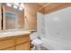 This bathroom features a single sink, toilet, bathtub, and tiled walls at 8024 Hackberry Dr, Las Vegas, NV 89123