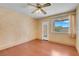 Bedroom with wood flooring, ceiling fan, and a bright window at 8024 Hackberry Dr, Las Vegas, NV 89123