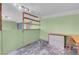 A bedroom featuring built-in shelves, desk, light green walls, and access to other rooms at 8024 Hackberry Dr, Las Vegas, NV 89123