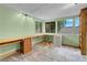 Bright bedroom with three windows, built-in desk with filing cabinets, and light green walls at 8024 Hackberry Dr, Las Vegas, NV 89123