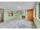 Versatile bonus room featuring built-in shelving, carpet, and ample natural light at 8024 Hackberry Dr, Las Vegas, NV 89123