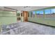 Spacious bonus room with shelving, large windows, and neutral carpeting at 8024 Hackberry Dr, Las Vegas, NV 89123