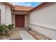 Inviting front entrance with a red double-door and desert landscaping at 8024 Hackberry Dr, Las Vegas, NV 89123