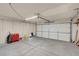 View of garage with large door, overhead lighting, and storage shelves at 8024 Hackberry Dr, Las Vegas, NV 89123