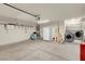 Garage view with storage shelves, utility sink, washer, dryer and garage door at 8024 Hackberry Dr, Las Vegas, NV 89123
