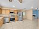 Well-lit kitchen featuring stainless steel appliances, granite countertops, and tiled flooring at 8024 Hackberry Dr, Las Vegas, NV 89123