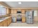 Bright kitchen with stainless steel appliances and oak cabinets at 8024 Hackberry Dr, Las Vegas, NV 89123