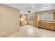 Spacious kitchen area with tiled floors, wood cabinets, double sink, and natural light at 8024 Hackberry Dr, Las Vegas, NV 89123