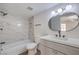Contemporary bathroom featuring a stylish vanity, modern lighting, and a tiled shower and tub at 8101 W Flamingo Rd # 1035, Las Vegas, NV 89147