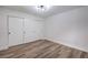 Bedroom featuring wood-look floors, white walls, and closet with sliding doors at 8101 W Flamingo Rd # 1035, Las Vegas, NV 89147