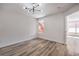 This airy bedroom boasts wood-look floors, neutral walls, and a bright window at 8101 W Flamingo Rd # 1035, Las Vegas, NV 89147